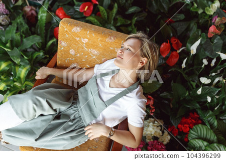 Small business entrepreneur owner,happy woman sitting with flowers at florist shop service job. Portrait of caucasian girl successful owner environment, top view 104396299