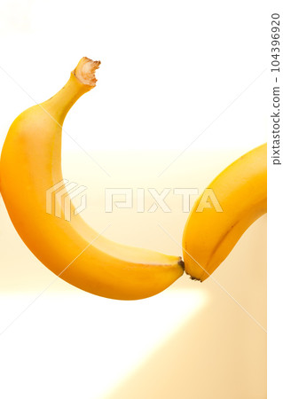 two sexy bananas touching each other. happy Banana fruits levitation on white background 104396920
