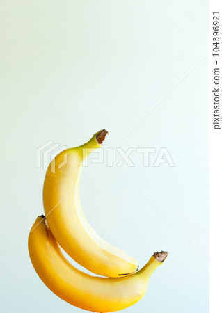 two sexy bananas touching each other. happy Banana fruits levitation on white background two sexy bananas touching each other. happy Banana fruits levitation on white background 104396921