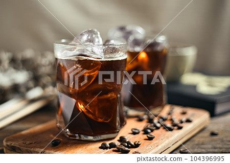 Iced americano coffee with coffee beans Iced americano coffee with coffee beans 104396995