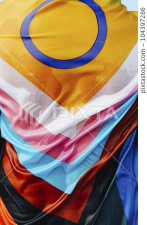 person wrapped in a wet progress pride flag 104397286