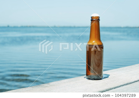 refreshing beer bottle on the pier refreshing beer bottle on the pier 104397289