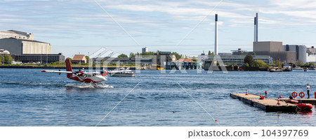 Small modern propeller business charter seaplane landing at Copenhagen water harbour. Sea plane aerial view city sightseeing tour. Cityscape scandinavian Denmark city landmark travel trip Small modern propeller business charter seaplane landing at Copenhagen water harbour. Sea plane aerial view city sightseeing tour. Cityscape scandinavian Denmark city landmark travel trip 104397769