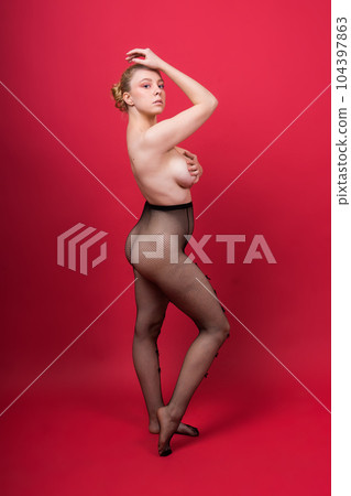 Young beautiful seductive woman with large breasts. Carefree model wearing lingerie. 104397863