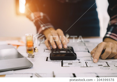 civil engineer or architect business useing calculator about calculate the cost with for working building plan design project in office. civil engineer or architect business useing calculator about calculate the cost with for working building plan design project in office. 104399378