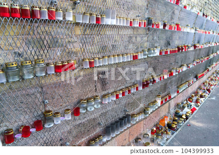 many candles on the wall on the day of remembrance of the victims. many candles on the wall on the day of remembrance of the victims. 104399933