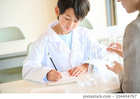Elementary school boy doing science experiments Elementary school boy doing science experiments 104404767