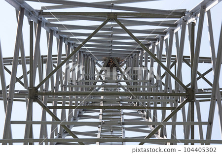 Metal electricity pole with visible bird nest 104405302