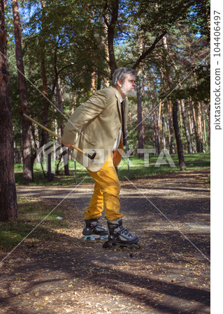Funny old man on roller skates and walking stick. Funny old man on roller skates and walking stick. 104406497