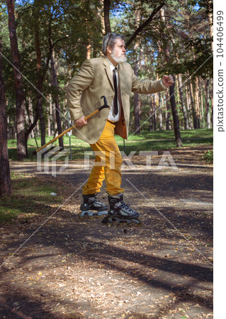 Funny old man on roller skates and walking stick. Funny old man on roller skates and walking stick. 104406499