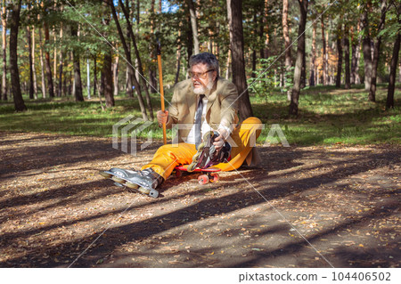 Funny old man on roller skates and walking stick. Funny old man on roller skates and walking stick. 104406502