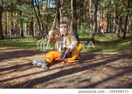Funny old man on roller skates and walking stick. Funny old man on roller skates and walking stick. 104406571