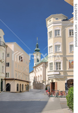 View into Linzer Gasse of Salzburg in Austria. Main pedestrian artery through the historical district on the right side of the river Salzach, with houses from 14th century and the St Sebastian church. View into Linzer Gasse of Salzburg in Austria. Main pedestrian artery through the historical district on the right side of the river Salzach, with houses from 14th century and the St Sebastian church. 104406776