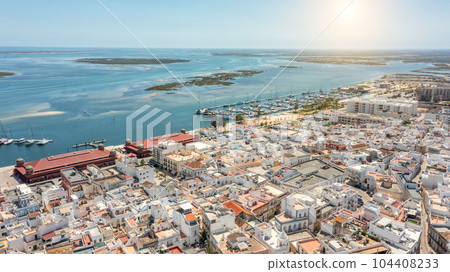 Aerial view on a sunny day, of Portuguese fishing tourist town of Olhao with a view the Ria Formosa Marine Park.  104408233