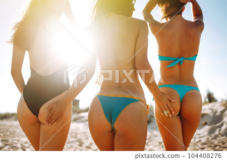 Three beautiful young girls on the beach. Excellent figures .enjoy summer time. Fun at the beach. Three beautiful young girls on the beach. Excellent figures .enjoy summer time. Fun at the beach. 104408276