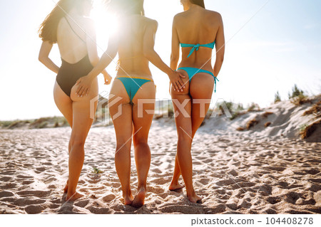 Three beautiful young girls on the beach. Excellent figures .enjoy summer time. Fun at the beach. Three beautiful young girls on the beach. Excellent figures .enjoy summer time. Fun at the beach. 104408278