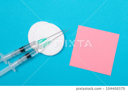 Vaccination or Revaccination Concept - Two Medical Syringe on Blue Table 104408370