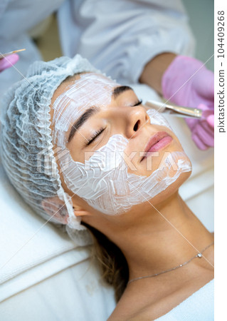 Cosmetology procedures for young woman in aesthetic clinic. 104409268
