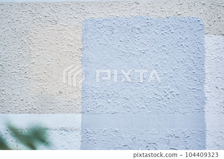 Fine-grained plaster applied by hand. Exterior plaster with space to copy. Warm colored blue background with the texture of rough grainy stone. High quality photo Fine-grained plaster applied by hand. Exterior plaster with space to copy. Warm colored blue background with the texture of rough grainy stone. High quality photo 104409323