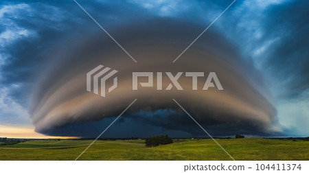 Angry supercell storm influenced by Climate change. Dangerous storm supercell shelf cloud with layers. Angry supercell storm influenced by Climate change. Dangerous storm supercell shelf cloud with layers. 104411374