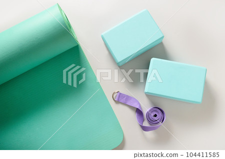 Green mat, yoga blocks and belt. Yoga practice, stretching concept. 104411585
