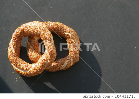 Turkish Bagel Simit on black background Turkish Bagel Simit on black background 104411713