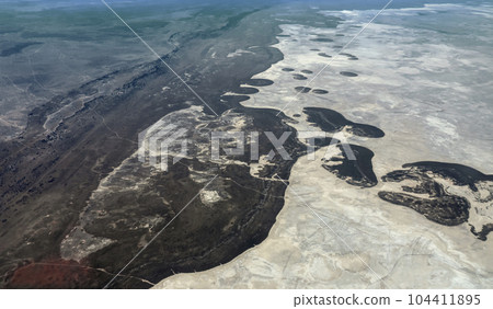 Seasonal salt lake Ntvetwe Pan, with changing coastline and evaporating surface in Botswana view from height of 1500 m. 104411895