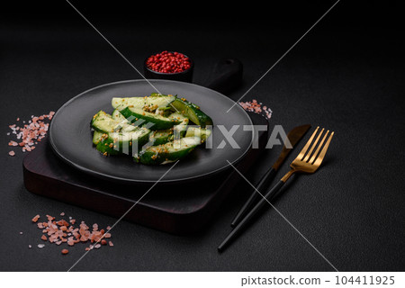 Delicious juicy cucumber cut into large slices with salt, spices and french mustard 104411925