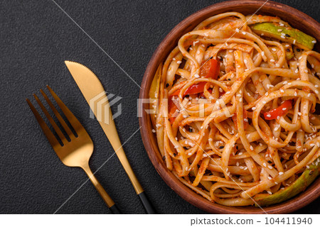 Delicious asian udon dish with vegetables, mushrooms, salt and spices 104411940