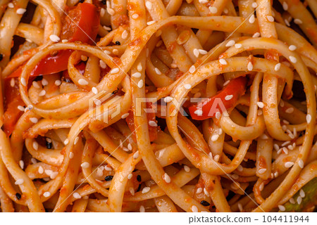 Delicious asian udon dish with vegetables, mushrooms, salt and spices 104411944