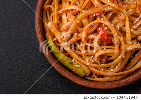 Delicious asian udon dish with vegetables, mushrooms, salt and spices Delicious asian udon dish with vegetables, mushrooms, salt and spices 104411947