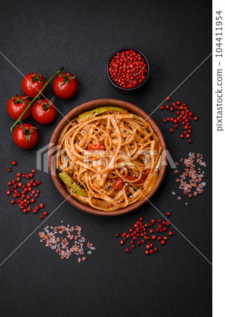Delicious asian udon dish with vegetables, mushrooms, salt and spices 104411954