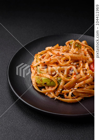 Delicious asian udon dish with vegetables, mushrooms, salt and spices 104411969