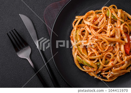 Delicious asian udon dish with vegetables, mushrooms, salt and spices Delicious asian udon dish with vegetables, mushrooms, salt and spices 104411970
