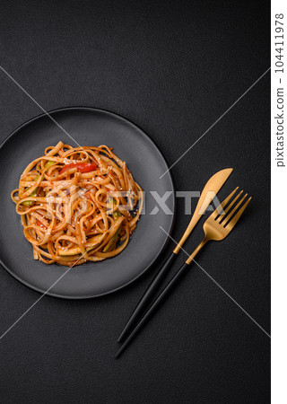 Delicious asian udon dish with vegetables, mushrooms, salt and spices 104411978