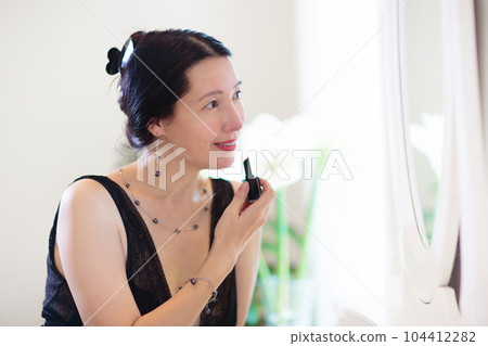 Young Asian woman looking in the mirror. 104412282