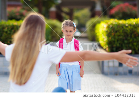 School pick up. Mother and kids after school. School pick up. Mother and kids after school. 104412315