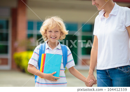 School pick up. Mother and kids after school. School pick up. Mother and kids after school. 104412339
