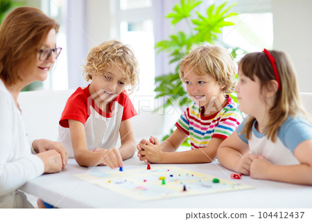 Family playing board game. Kids play. Family playing board game. Kids play. 104412437
