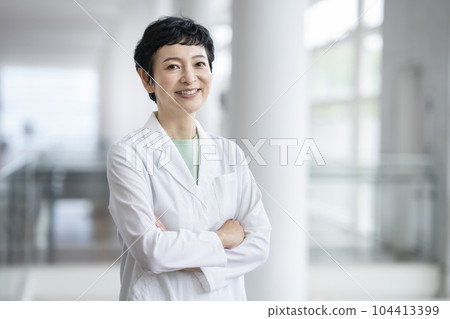 Arafif woman wearing a white coat looking at the camera portrait 104413399