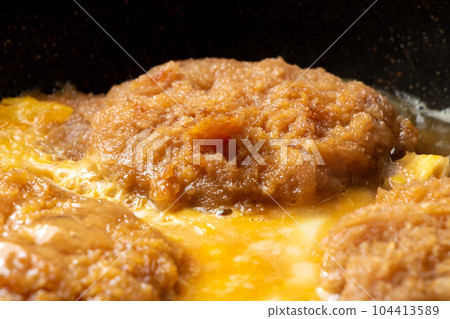 Deep-fried leftovers (pork cutlet) remake, egg binding (katsutoji) cooking scene. Deep-fried leftovers (pork cutlet) remake, egg binding (katsutoji) cooking scene. 104413589