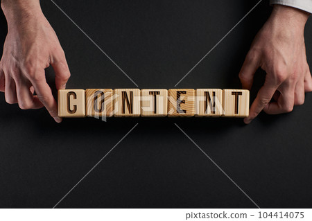 The word content on stacked wooden cubes with yellow background. 104414075