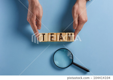 Wooden cubes with words TEAM, together everyone achieves more. Business, motivational and TEAM concept. Wooden cubes with words TEAM, together everyone achieves more. Business, motivational and TEAM concept. 104414104