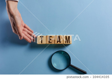 Wooden cubes with words TEAM, together everyone achieves more. Business, motivational and TEAM concept. 104414105