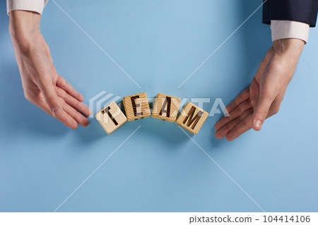 Wooden cubes with words TEAM, together everyone achieves more. Business, motivational and TEAM concept. 104414106