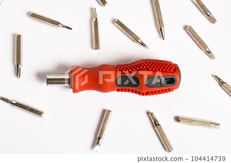 red screwdriver, white background and bits, spare parts 104414739