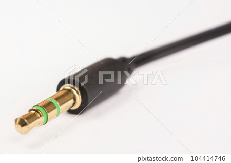 3.5mm headphone jack with wire lies on a white background isolate 104414746