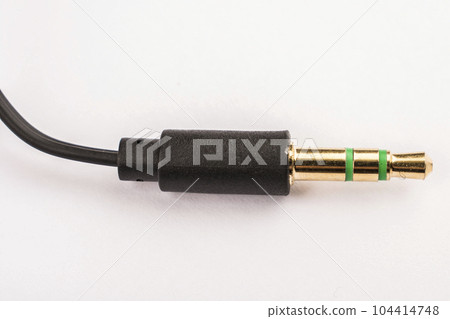 3.5mm headphone jack with wire lies on a white background isolate 104414748