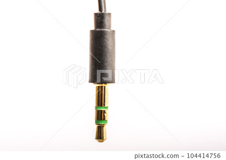 3.5mm headphone jack with wire lies on a white background isolate 104414756