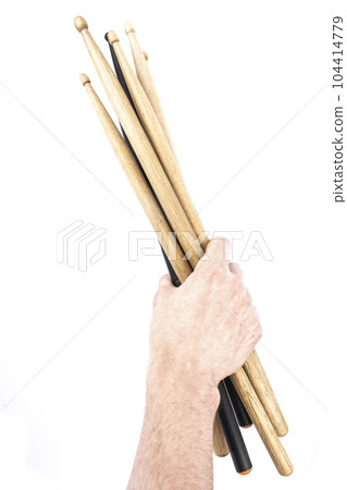 a lot of drumsticks of two colors in a hand, isolated on a white background 104414779